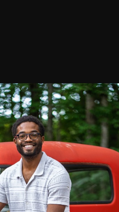 Kenon Johnson, owner of K&M Property Service, standing by his work truck in Albany, NY